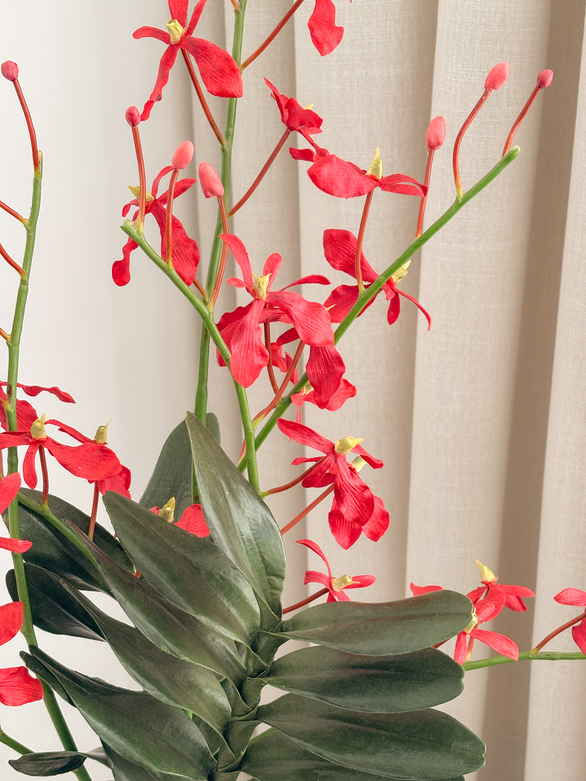 Detail view: red faux renanthera orchids by FAUX Dubai