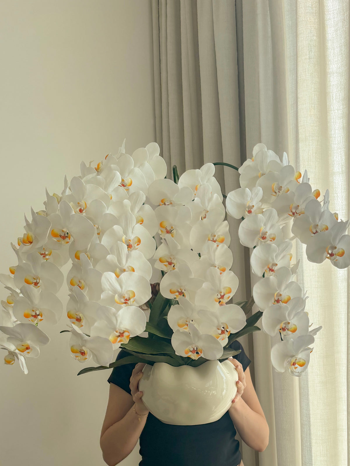 Extra large artificial white orchid arrangement shown for scale by FAUX Dubai